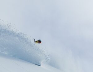 Dani Reyes-Acosta, Latina-AAPI athlete,backcountry snowboards deep powder snow on Teton Pass. Photo by Jr Rodriguez @JrRdgrz http://jrrdrgz.com